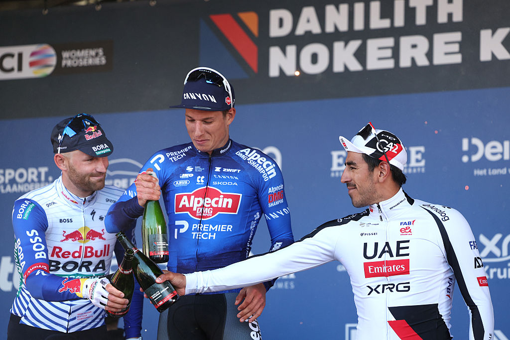 NOKERE, BELGIUM - MARCH 18: (L-R) Jordi Meeus of Belgium and Team Red Bull - BORA - hansgrohe on second place, race winner Jasper Philipsen of Belgium and Team Alpecin-Premier Tech and Juan Sebastian Molano of Colombia and UAE Team Emirates - XRG on third place pose on the podium ceremony after the 80th Danilith Nokere Koerse 2026, Men&amp;apos;s Elite a 186.4km one day race from Deinze to Nokere / #UCIWT / on March 18, 2026 in Nokere, Belgium. (Photo by Rhode Van Elsen/Getty Images)
