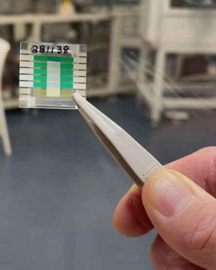 A researcher holds the tiny prototype quantum battery