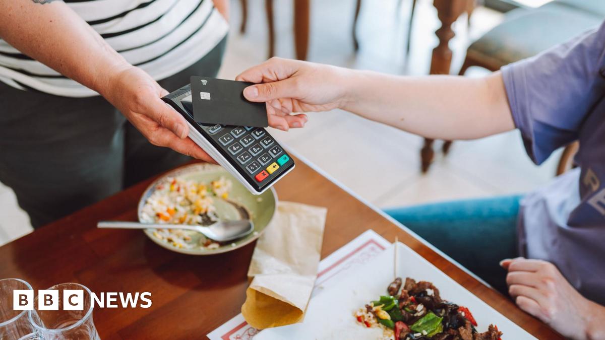 Person paying for food in a restaurant using contactless card