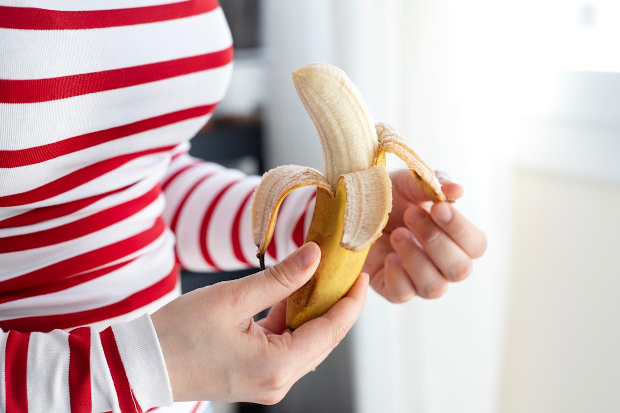 Woman hands peeling a banana