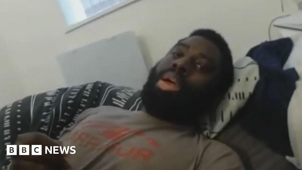 Valdo Calocane in front of a police car with three police officers who have their faces blurred out.