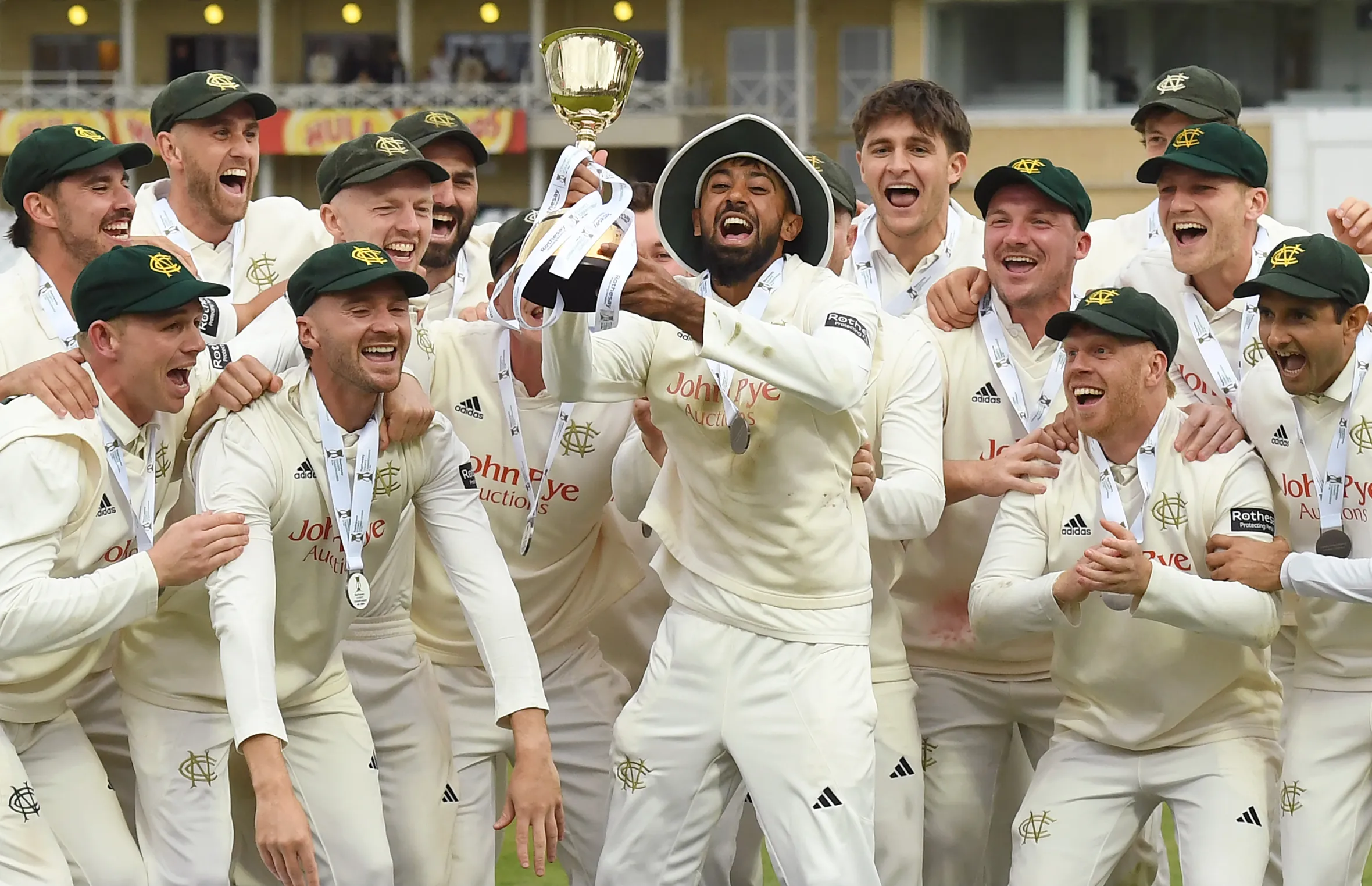 Nottinghamshire cricket team celebrating with the County Championship Trophy.