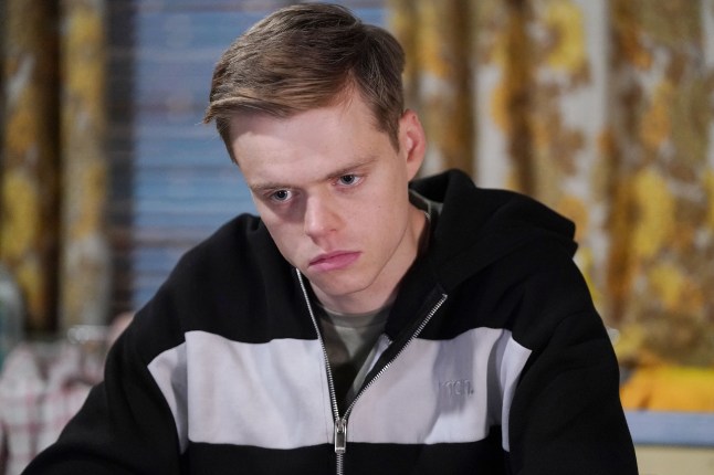 Oscar Branning looking miserable as he stands in Dot's old house in EastEnders.