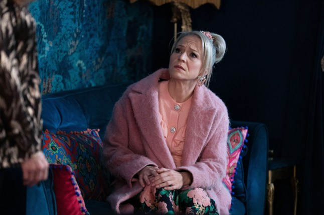 Linda sits down in the Boutique Hotel in EastEnders, looking distressed