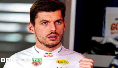 Max Verstappen wearing a white fireproof top in the Red Bull garage at the Japanese Grand Prix