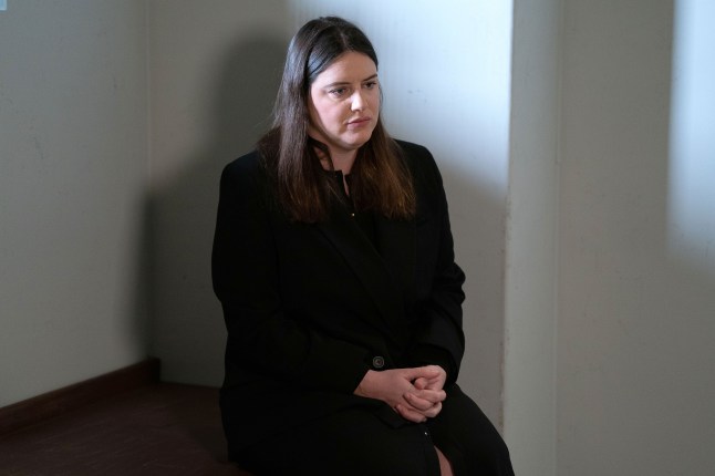 Zoe sits alone in her cell in EastEnders