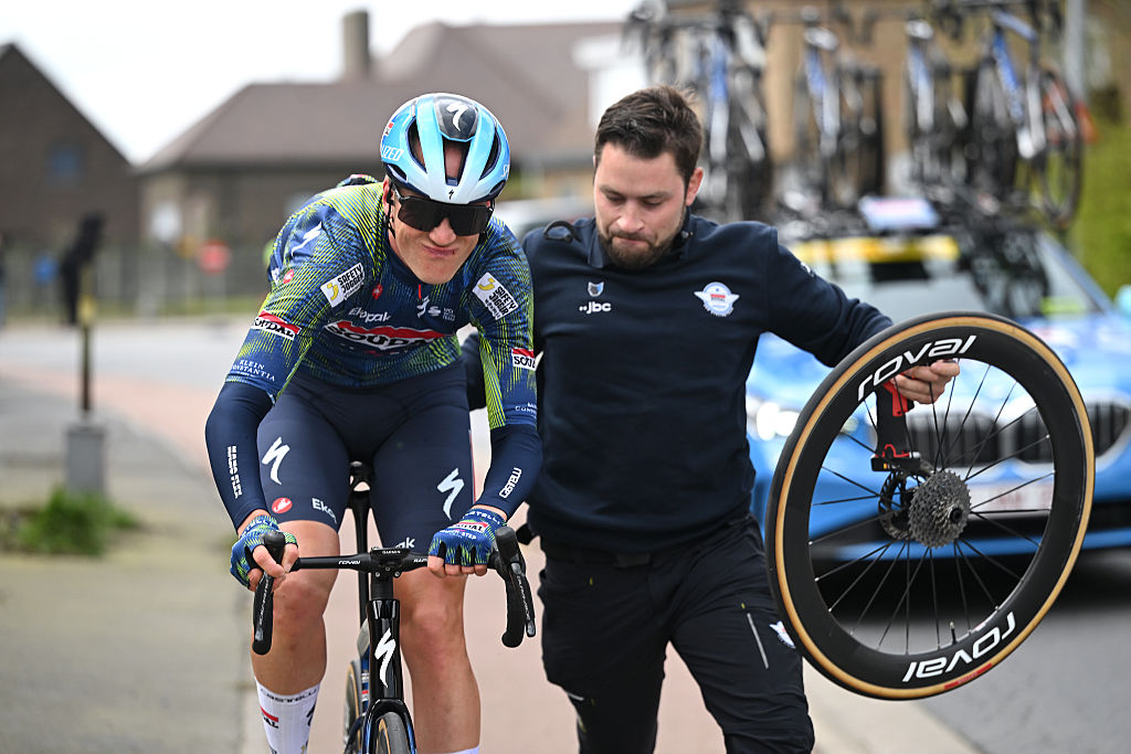 BRUGES, BELGIUM - MARCH 25: Dries Van Gestel of Belgium and Team Soudal Quick-Step assisted by the team car after being involved in a crash during the 50th Ronde Van Brugge - Tour of Bruges 2026 - Men&amp;apos;s Elite a 202.9km one day race from Bruges to Bruges / #UCIWT / on March 25, 2026 in Bruges, Belgium. (Photo by Luc Claessen/Getty Images)