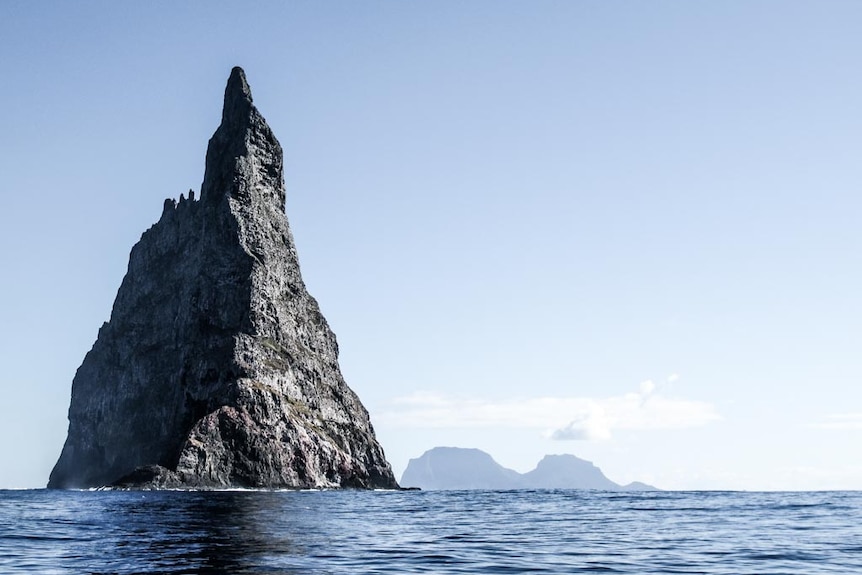 Large conical rock formation in the ocean