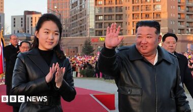 This picture taken on February 16, 2026 and released by North Korea's official Korean Central News Agency (KCNA) on February 17, 2026 shows North Korean leader Kim Jong Un (C) and his daughter Ju Ae (L) responding to citizens at the inauguration ceremony of 10,000 flats at fourth stage in Hwasong area of Pyongyang.