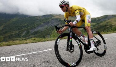Tadej Pogacar in yellow cycling gear, in action on a mountain road during the 2025 Tour de France