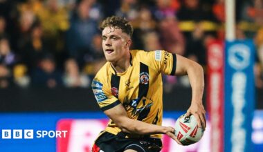Fletcher Rooney running with the ball in a Castleford Tigers yellow and black kit