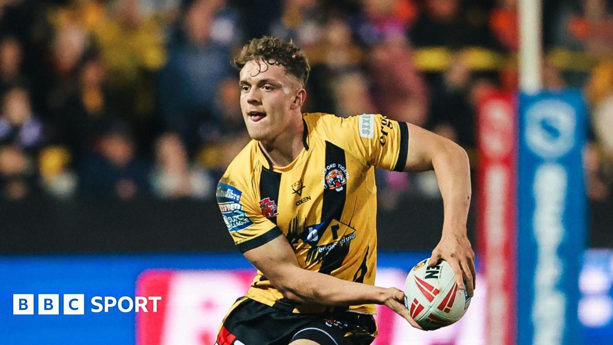 Fletcher Rooney running with the ball in a Castleford Tigers yellow and black kit