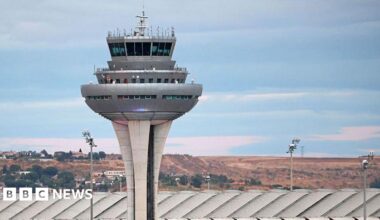 Two soldiers walk towards the naval base of Rota
