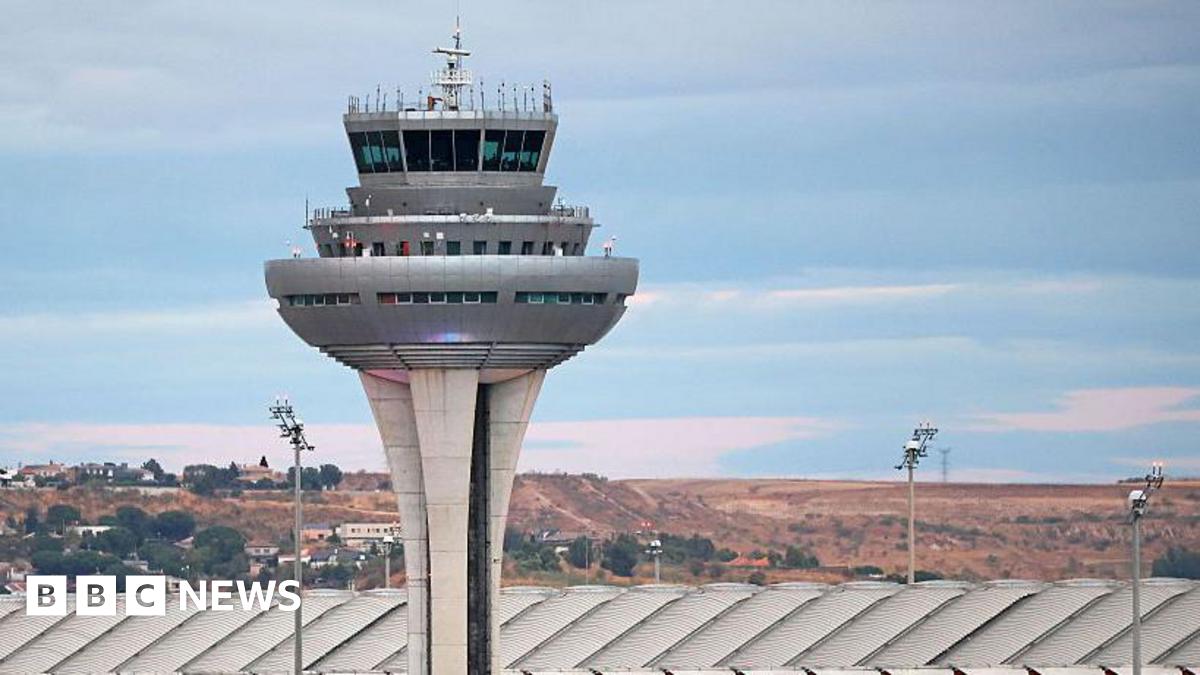 Two soldiers walk towards the naval base of Rota