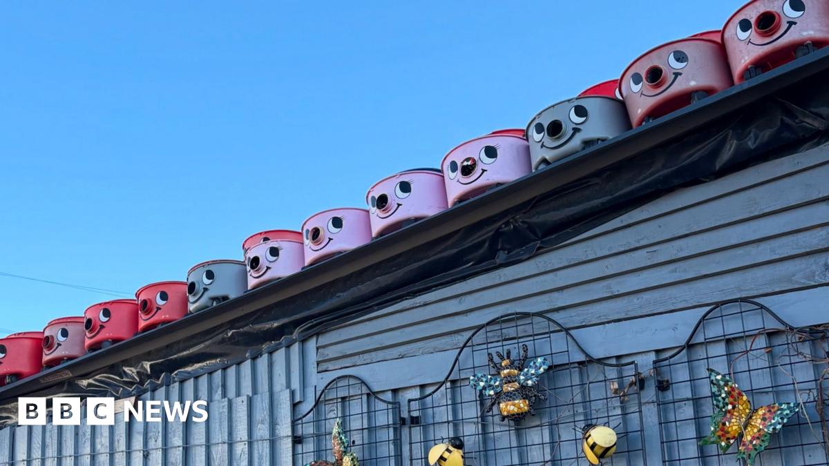 A shop stands beneath a clear blue sky. The shop name is Tecso - in the same red type used by supermarket Tesco. Underneath the name, in white lettering on a green background, is spelled: Furniture Clarance.