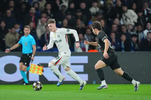 Cole Palmer running past Joao Neves