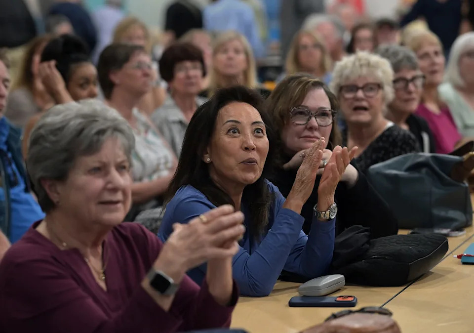 Wingfield Springs residents react during a meeting that was held at Sky Ranch Middle School on Thursday, March 12, 2026, to discuss the proposed project to build 764 residential units on the Red Hawk Golf Course.