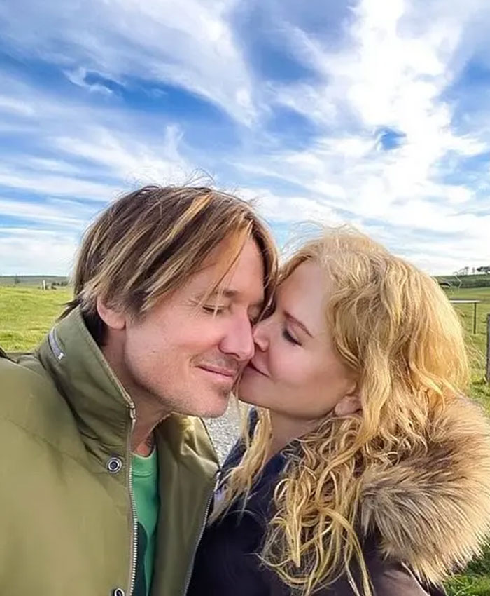 Nicole Kidman and Keith Urban sharing a tender moment outdoors under a bright sky, highlighting their relationship. Nicole Kidman and Keith Urban sharing a tender moment outdoors under a bright sky, highlighting their relationship.