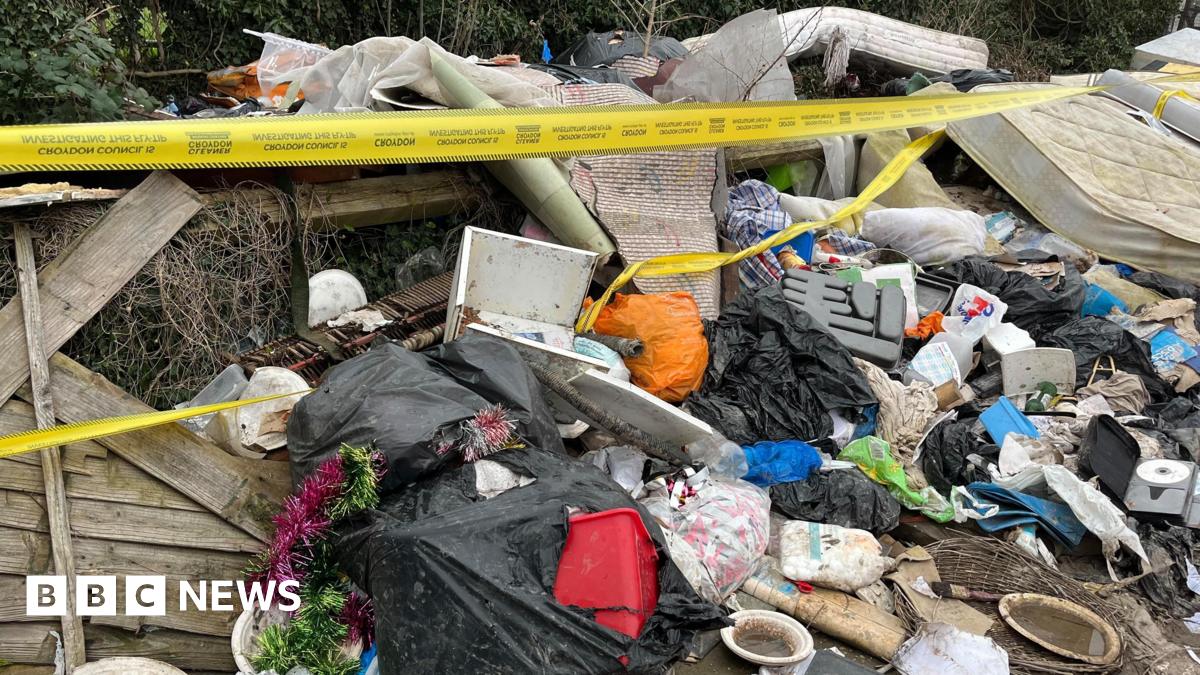 A pile of rubbish including mattresses, black bin bags is covered in yellow tape.