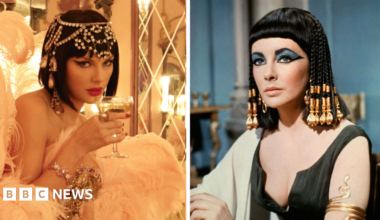 Taylor Swift and Elizabeth Taylor pictured in a split photograph. On the left, Swift is wearing a bejewelled headpiece and a black wig, while holding a glass of champagne to her lips. On the right, Elizabeth Taylor wears a similar wig, while posing on the set of her 1963 film Cleopatra.
