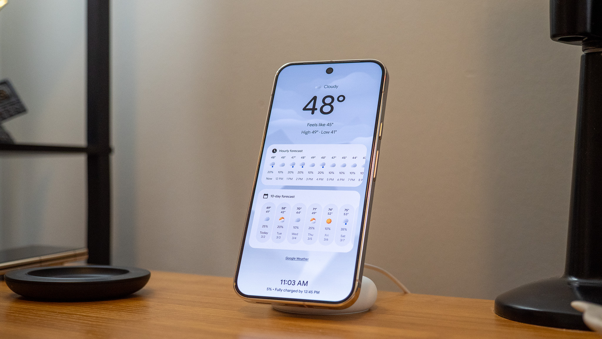 A Google Pixel 10 Pro XL on a Pixelsnap wireless charger with the screensaver function activated