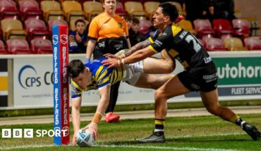 Warrington's Josh Thewlis dives to score a try inside the corner post under pressure from York's Nikau Williams