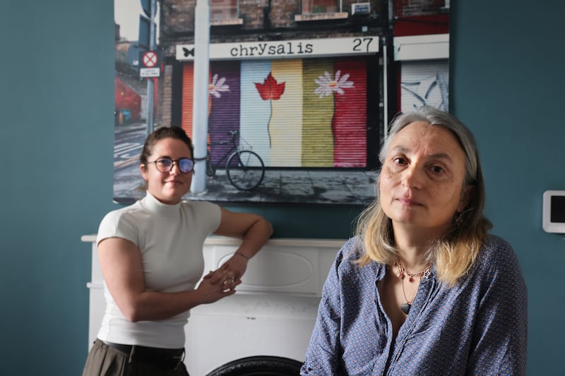 Sarah McGillivary and Passerose Mantoy in front of a photograph of Chrysalis by Derek Speirs in their Stoneybatter office. Photograph: Dara Mac Dónaill