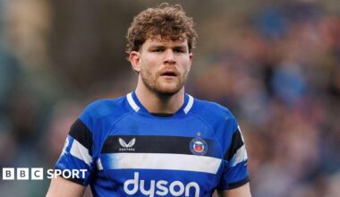 Ethan Staddon standing on the pitch during a match wearing Bath kit