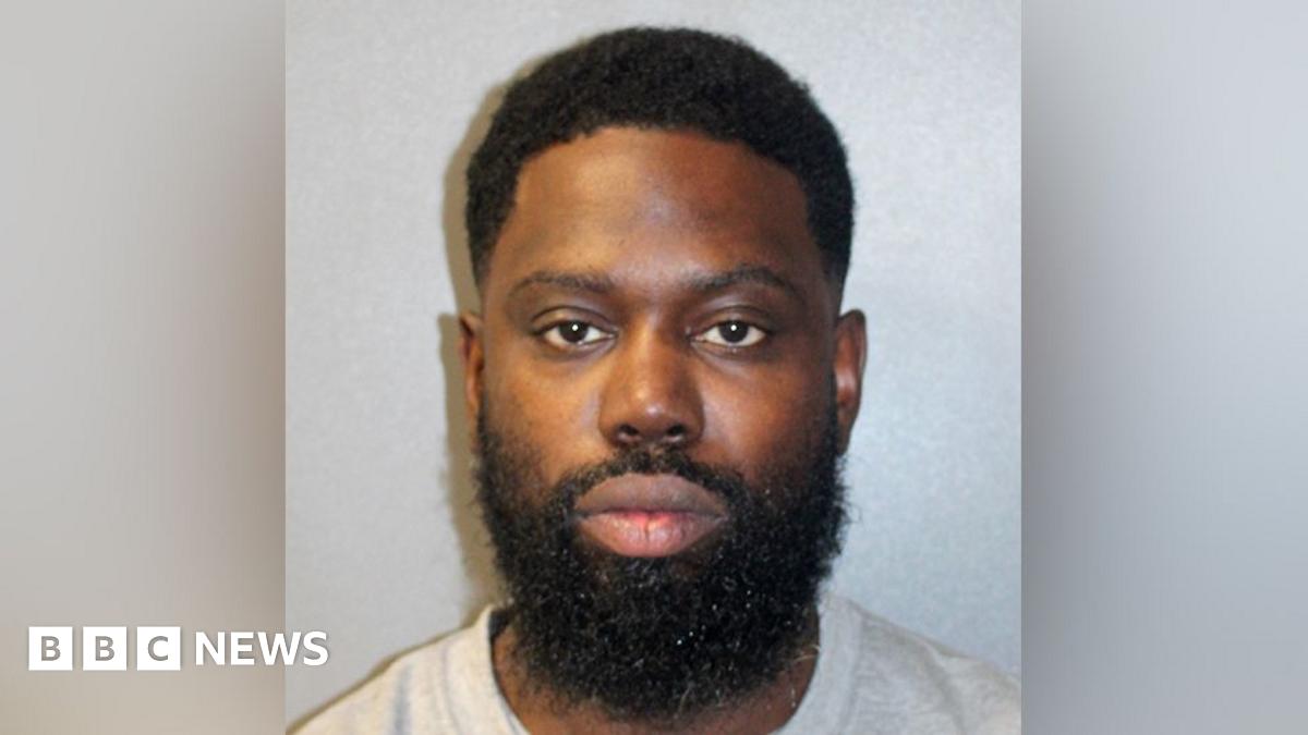 A custody image of Justin Clarke-Samuel in a grey T-shirt.