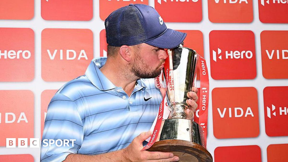 Alex Fitzpatrick kisses the Indian Open trophy