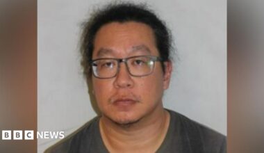 Vincent Chan mugshot shows a man with black hair wearing glasses and a grey jumper