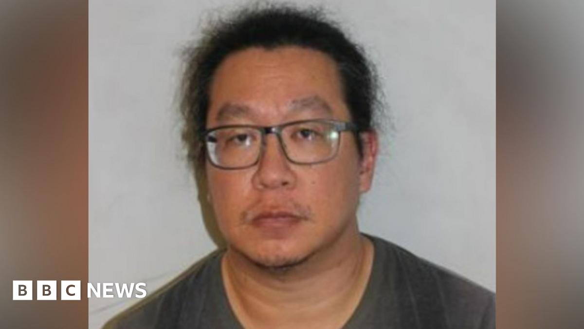 Vincent Chan mugshot shows a man with black hair wearing glasses and a grey jumper
