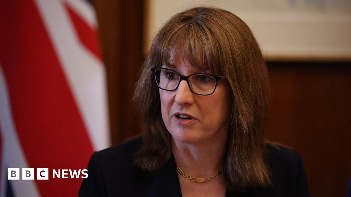 UK Chancellor Rachel Reeves wearing glasses and a black suit jacket.