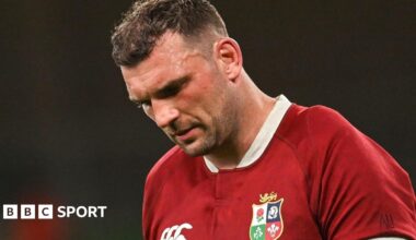 British and Irish Lions players pose after arriving in Australia., alongside a person in a kangaroo costume