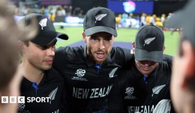 New Zealand captain Mitchell Santner addresses his players in a huddle