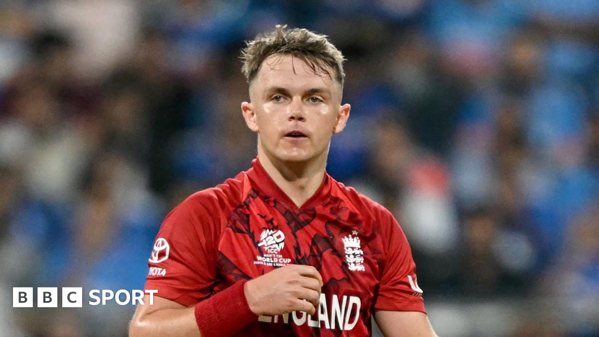 Sam Curran wearing a red England jersey
