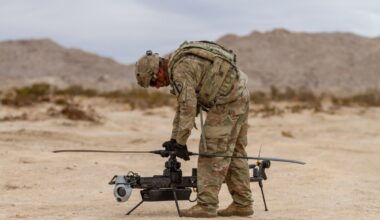 A US soldier prepares an Anduril-built drone for flight during a training exercise.