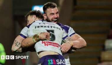Try scorer Tom Johnstone is lifted off the turf in celebration by Wakefield captain Mike McMeeken