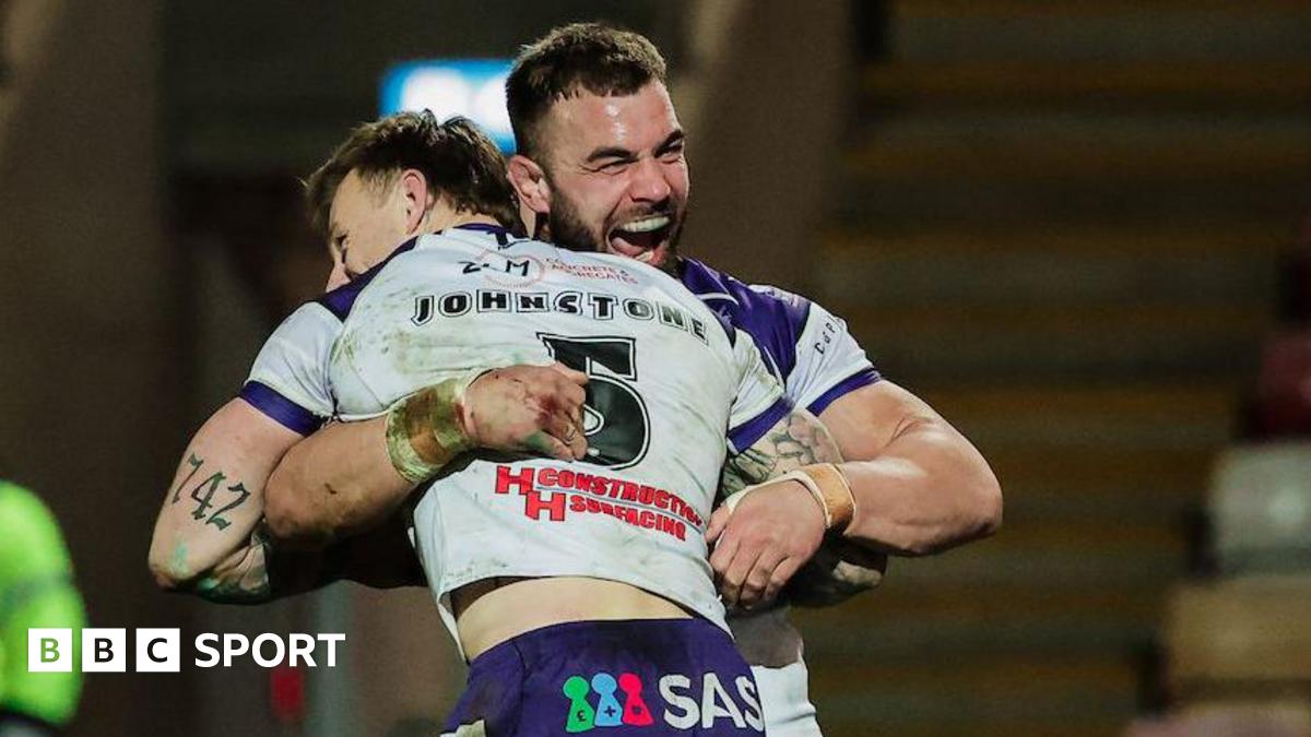 Try scorer Tom Johnstone is lifted off the turf in celebration by Wakefield captain Mike McMeeken