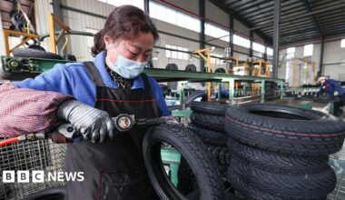 A woman processes tyre orders at a vehicle factory in China