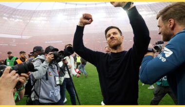 Xabi Alonso throws his arms in the air in celebration.