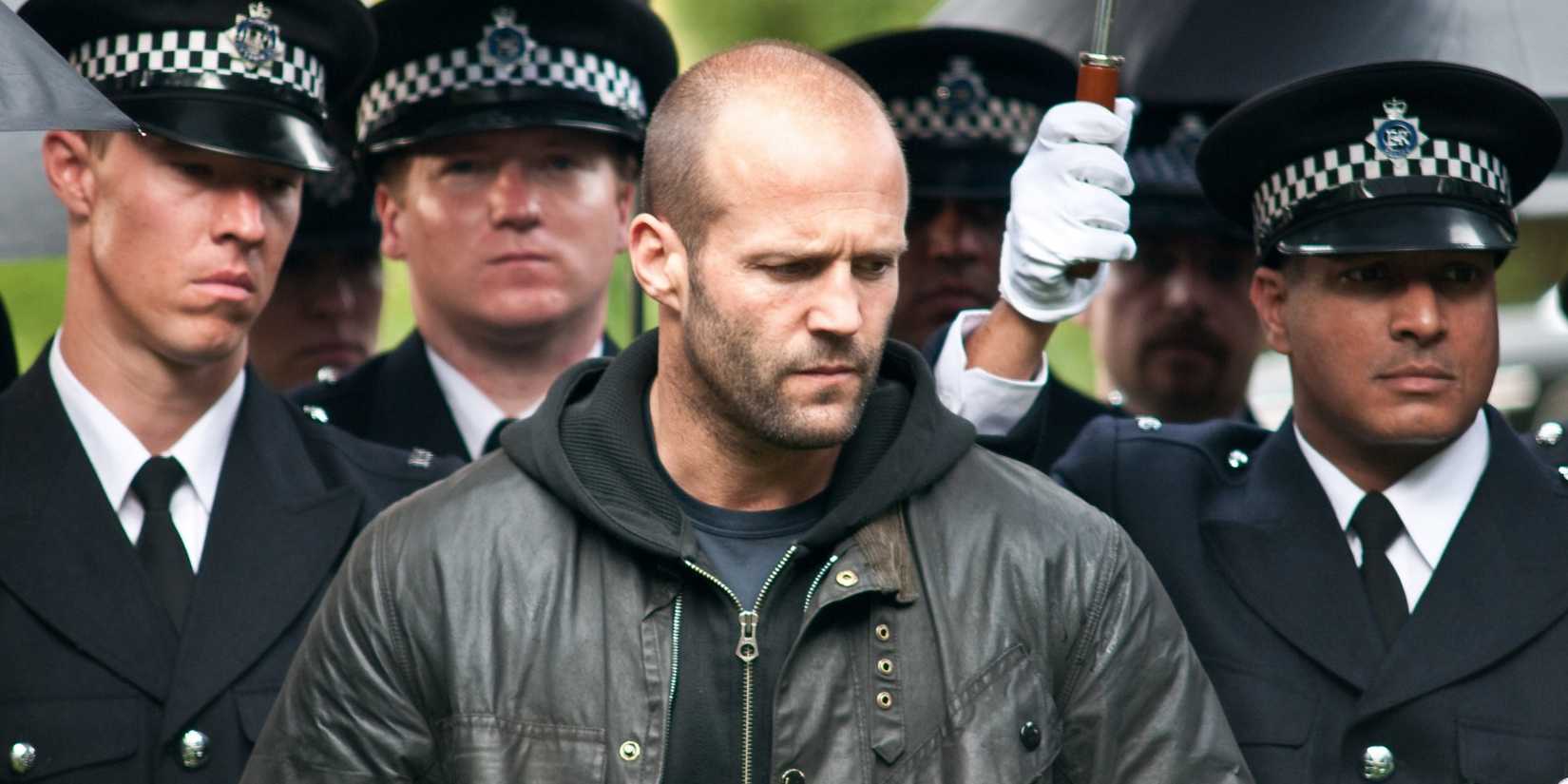 Jason Statham surrounded by uniformed police seemingly at a funeral in 'Blitz' 