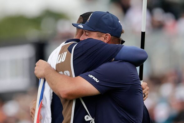 Bryson Dechambeau (R) hugs caddie after LIV win
