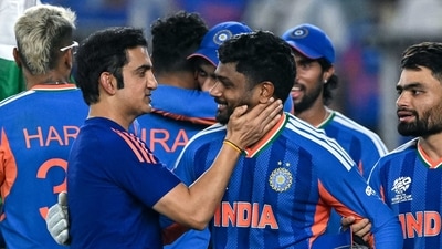 Sanju Samson (C) celebrates with his coach Gautam Gambhir (L) after their team's win in the 2026 T20 World Cup final match against New Zealand in Ahmedabad (AFP)