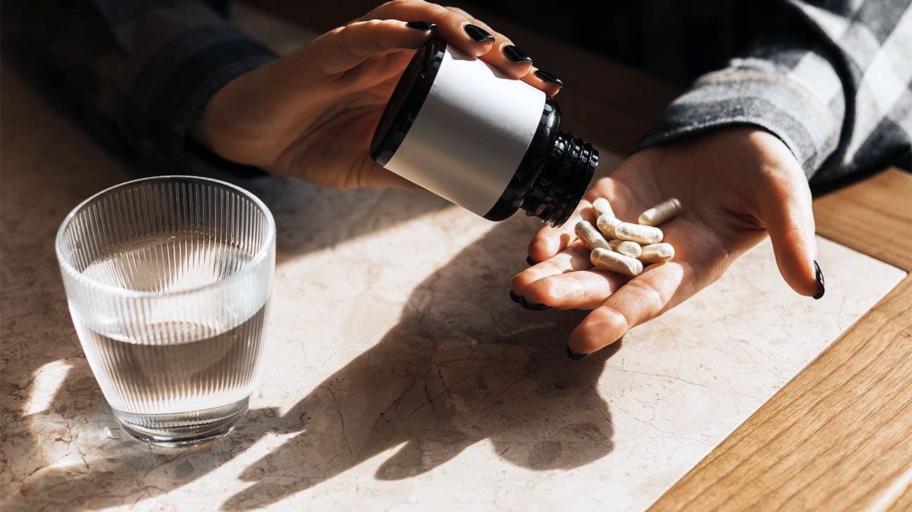 Bottle of collagen supplements poured into hand
