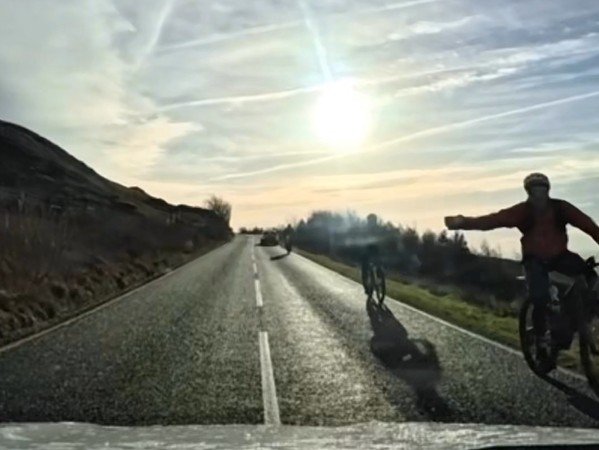 Driving instructor close passes cyclist on climb
