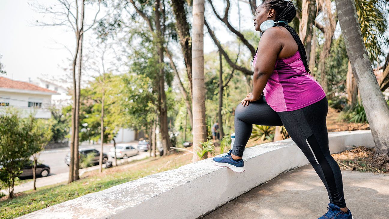 Female stretching hamstrings outdoors