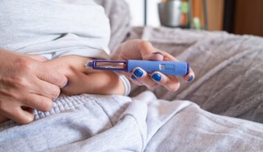 Close up of seated woman injecting weight loss drug GLP-1 into abdomen