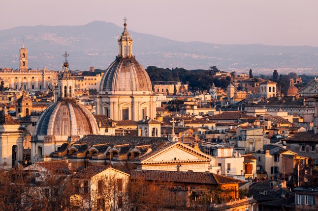 Rome skyline with domes of catholic churches at sunset, Lazio, Italy