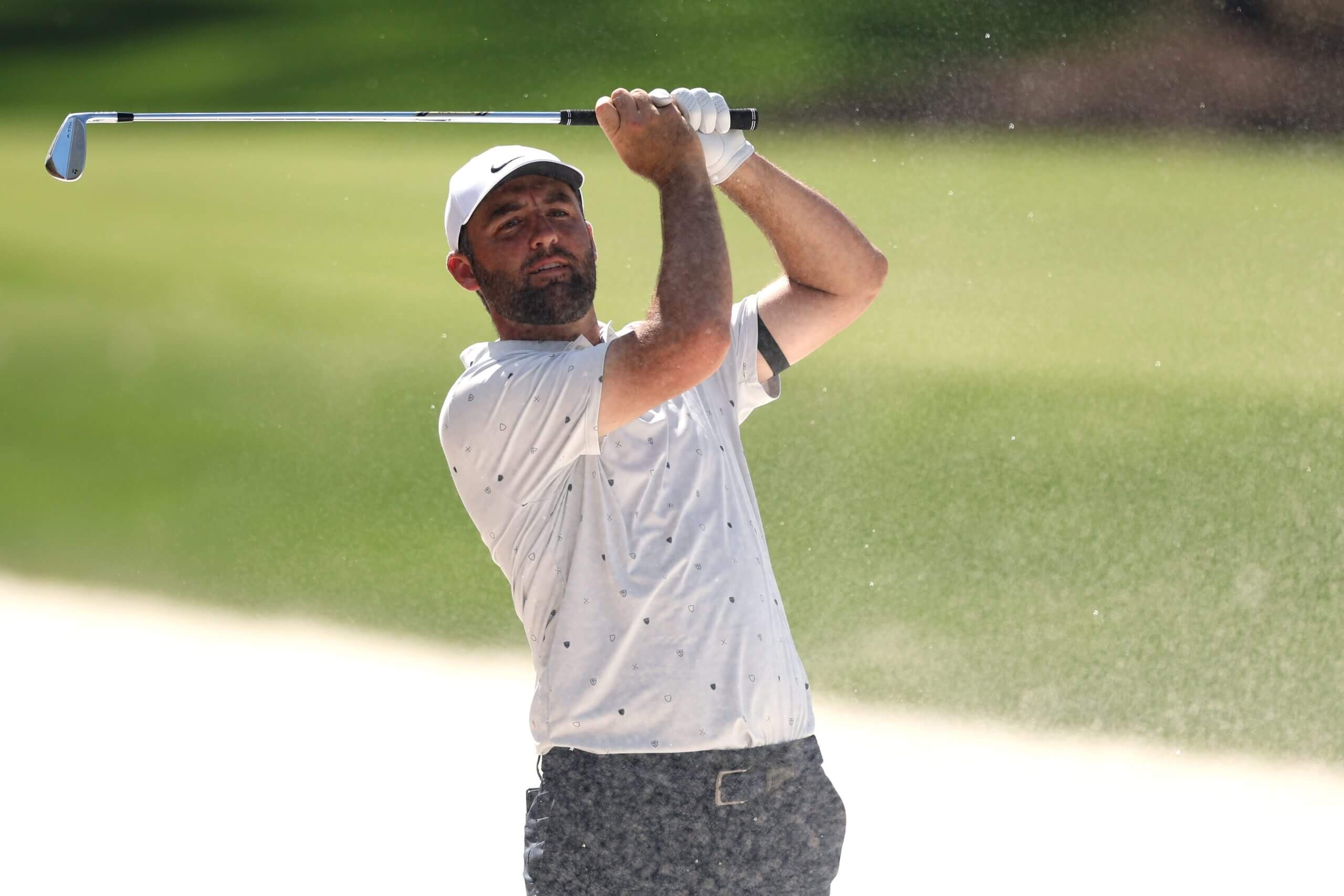 Scottie Scheffler swings from a bunker during a practice round at The Players Championship.